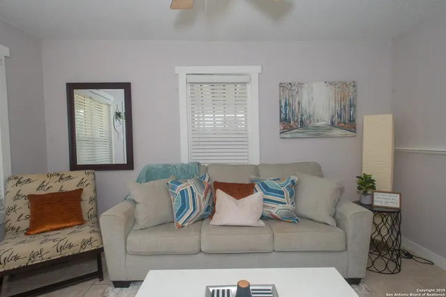 a living room with furniture and a dining table
