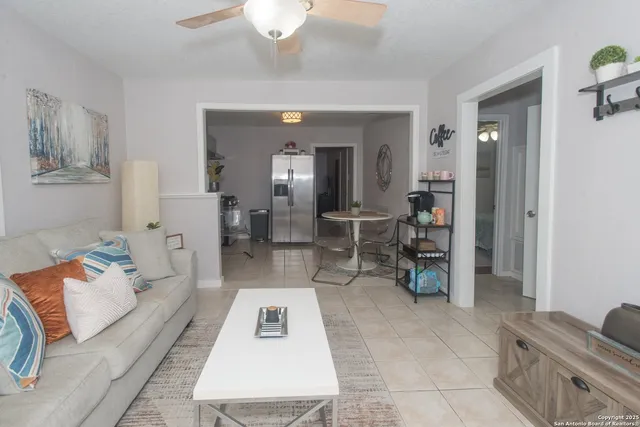 a living room with a couch and chandelier