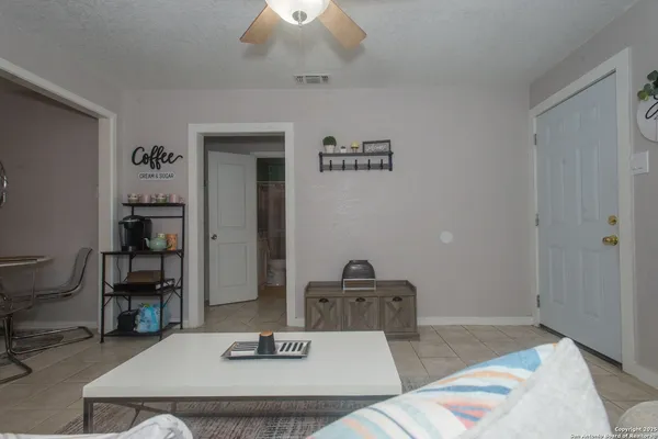a living room with furniture and a chandelier