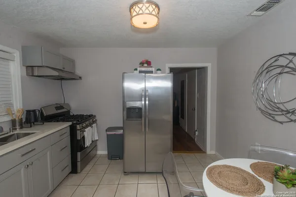 a kitchen with a sink stove and refrigerator