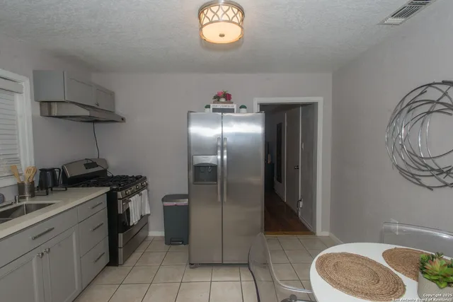 a kitchen with a sink stove and refrigerator