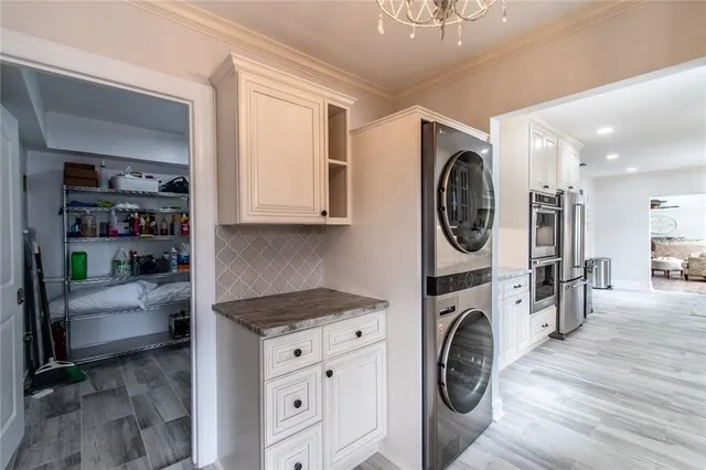 a utility room with sink dryer and washer