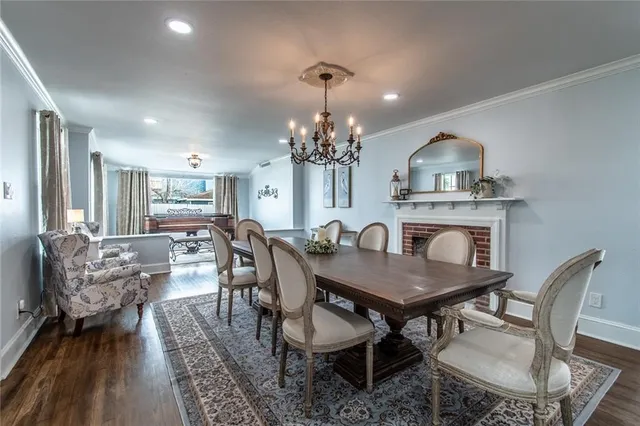 a view of a dining room with furniture and chandelier