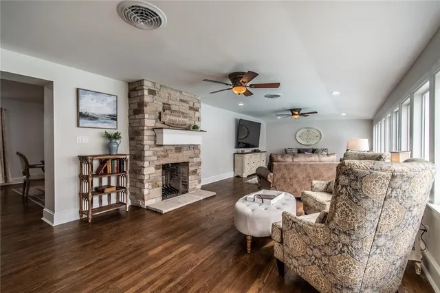 a living room with furniture fireplace and wooden floor