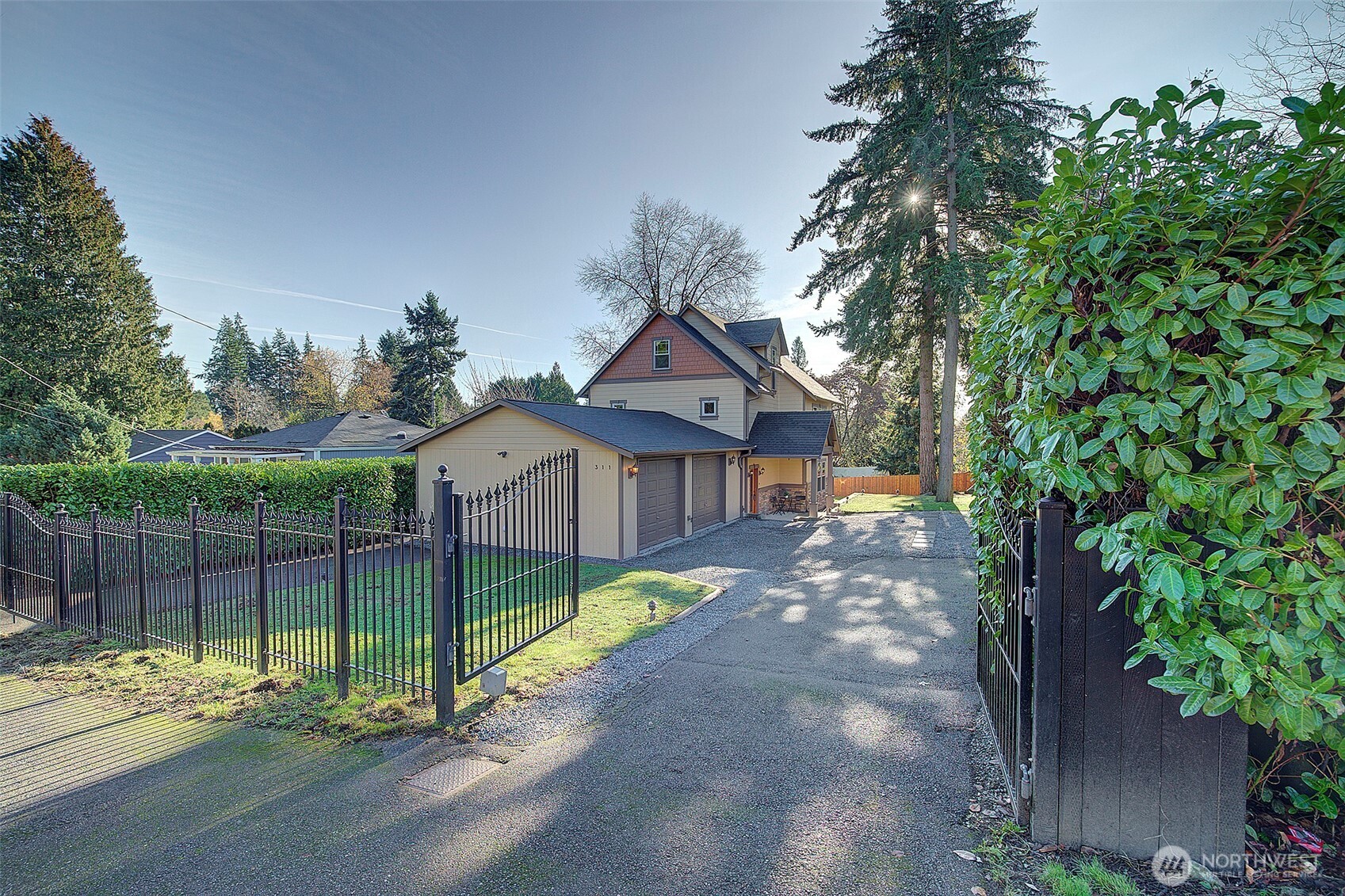 311 Northeast 117th Street Seattle, WA 98125 - Photo 2 of 40 a view of a house with a small yard and large trees