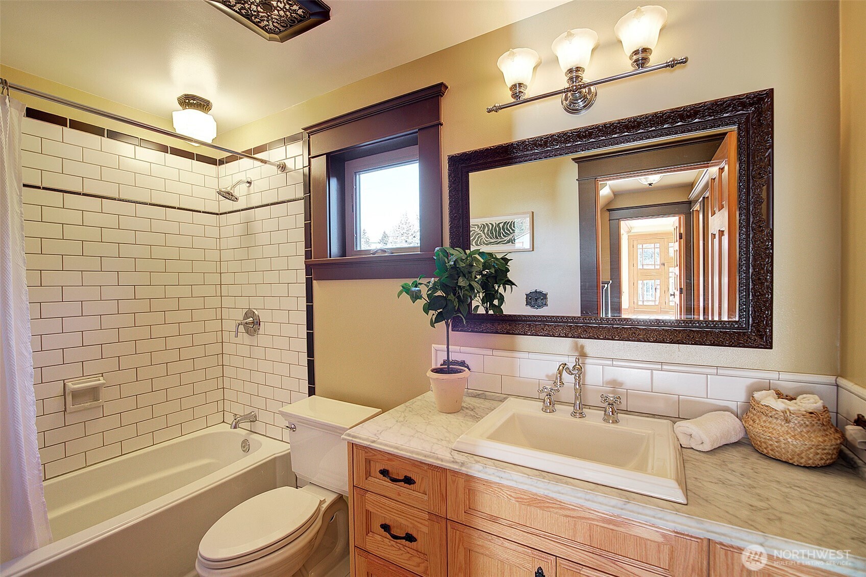 311 Northeast 117th Street Seattle, WA 98125 - Photo 31 of 40 a bathroom with a granite countertop sink toilet mirror and shower