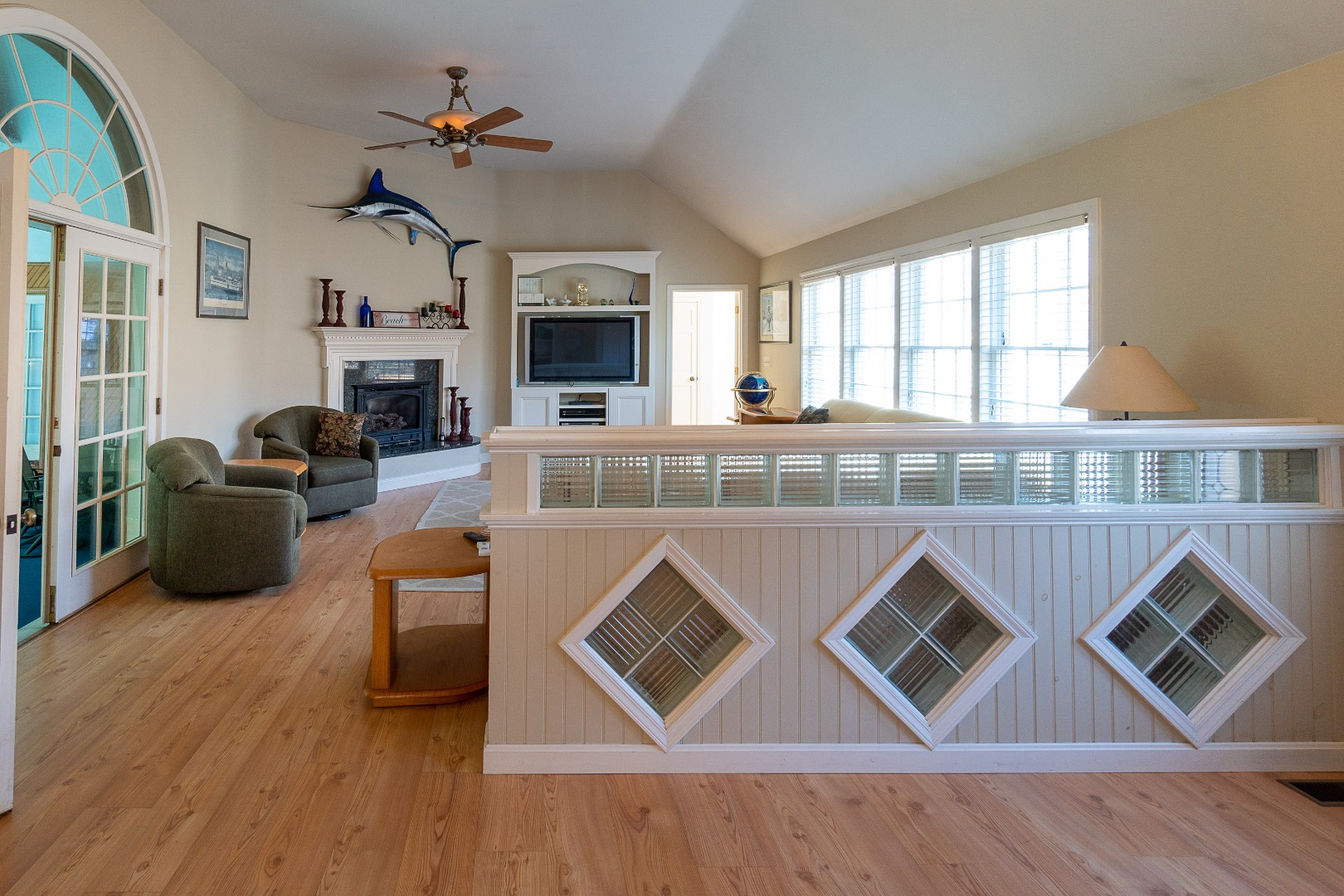 35 Pine Crest Drive Nantucket, MA 02554 - Photo 19 of 44 a living room with furniture a fireplace and a floor to ceiling window