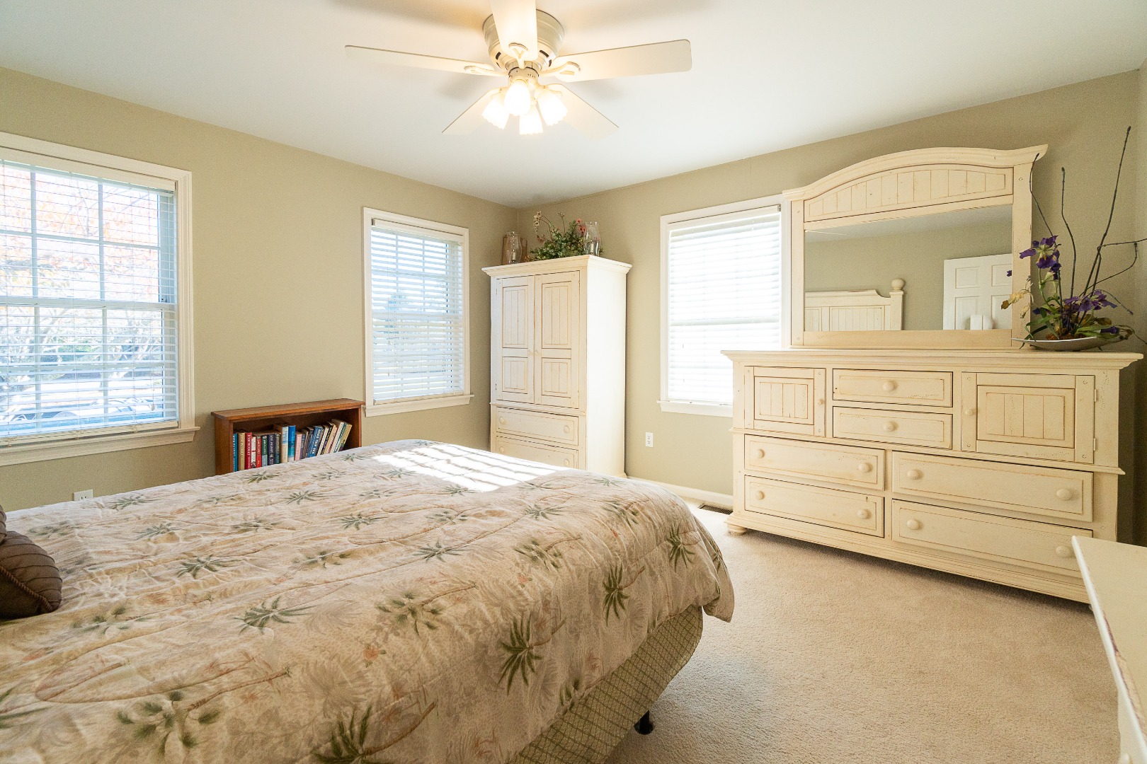35 Pine Crest Drive Nantucket, MA 02554 - Photo 26 of 44 a spacious bedroom with a large bed and a chandelier