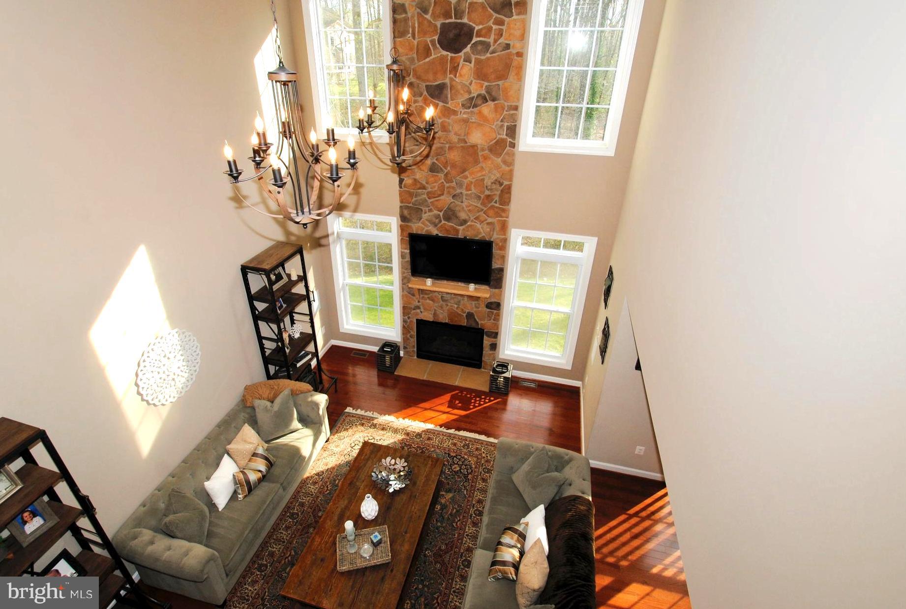 1490 Shot Town Road Annapolis, MD 21409 - Photo 10 of 40 Soaring Stone Fireplace w/Tall Window Sidelights