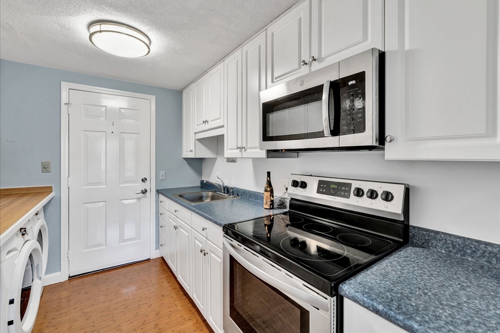 78 Highview Drive, Unit 78 Sandwich, MA 02563 - Photo 3 of 20 a kitchen with granite countertop a stove microwave and sink