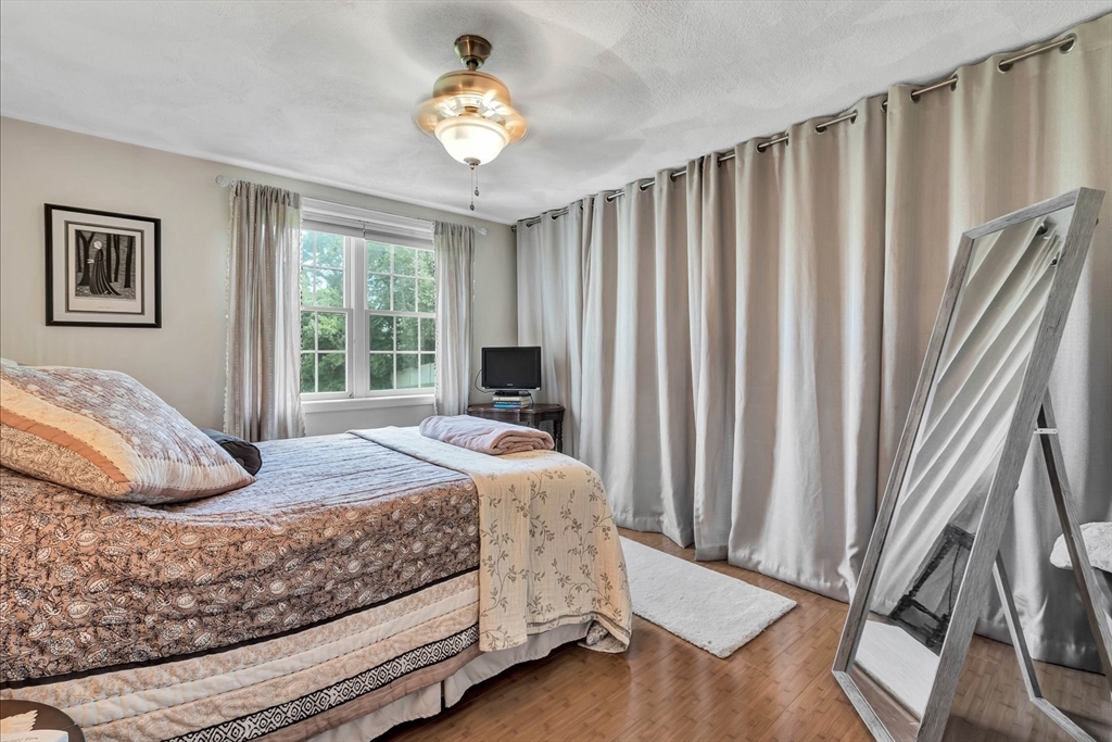 78 Highview Drive, Unit 78 Sandwich, MA 02563 - Photo 8 of 20 a bedroom with a bed and a large window