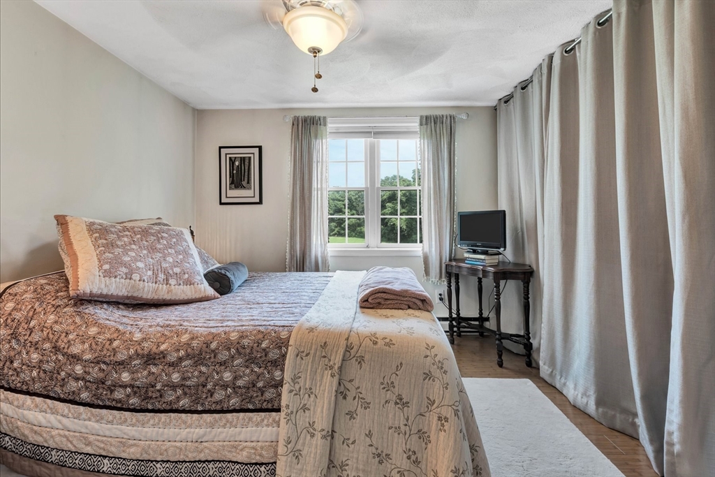 78 Highview Drive, Unit 78 Sandwich, MA 02563 - Photo 9 of 20 a bedroom with a bed and a flat tv screen on dresser