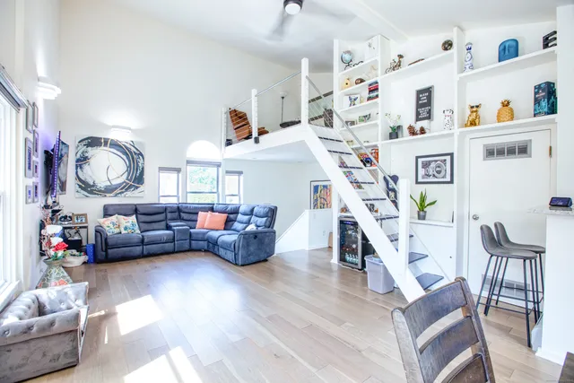 a living room with furniture and a wooden floor
