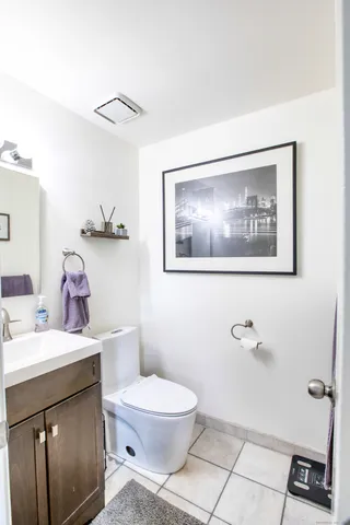 a bathroom with a toilet a sink and mirror