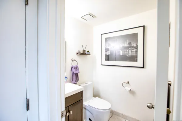 a white toilet sitting next to a bathroom sink