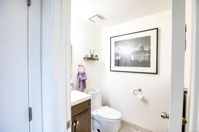 a white toilet sitting next to a bathroom sink