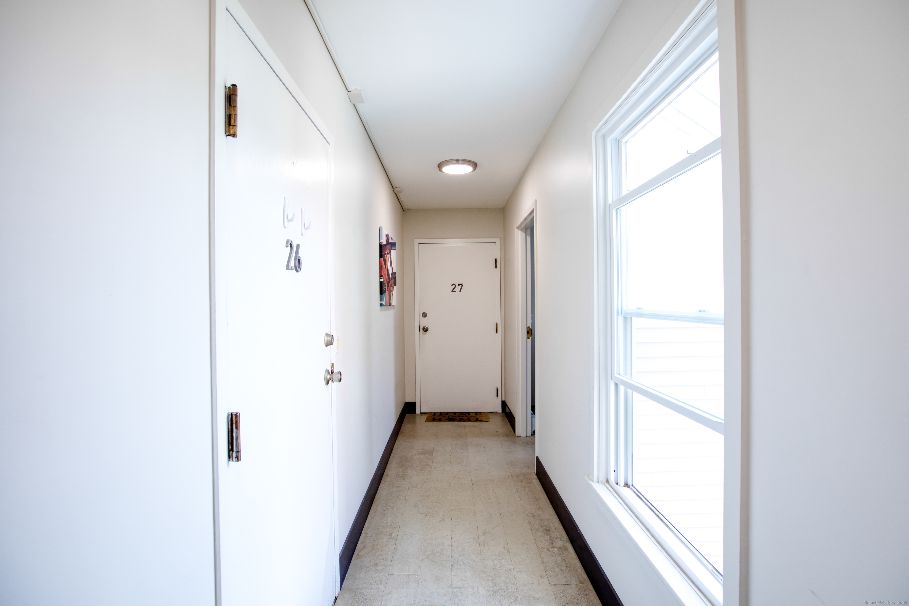 32 Pine Street, Unit 27 Norwalk, CT 06854 - Photo 21 of 25 a view of a hallway with a window