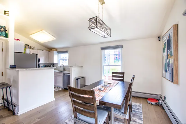 a view of a dining room with furniture window and wooden floor