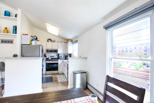 a kitchen with a refrigerator and windows