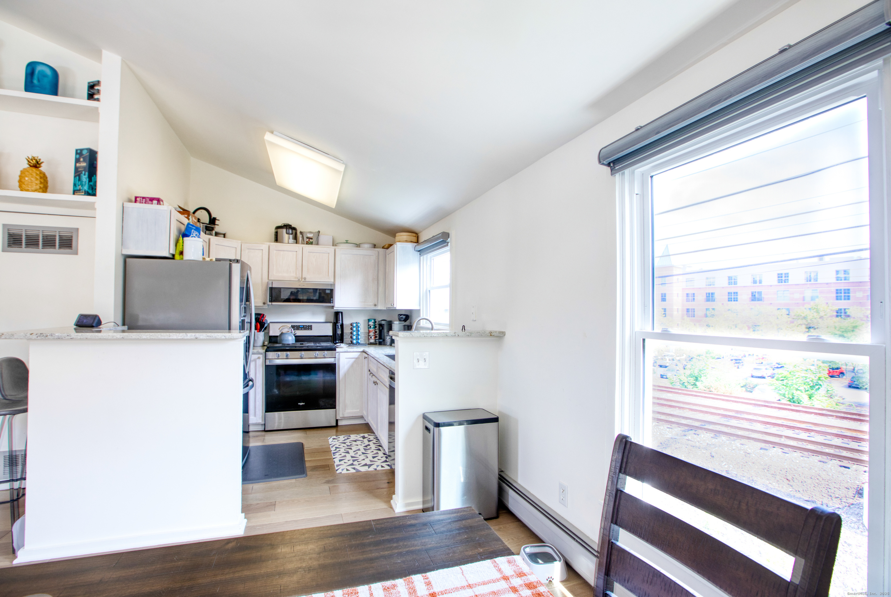 32 Pine Street, Unit 27 Norwalk, CT 06854 - Photo 6 of 25 a kitchen with a refrigerator and windows