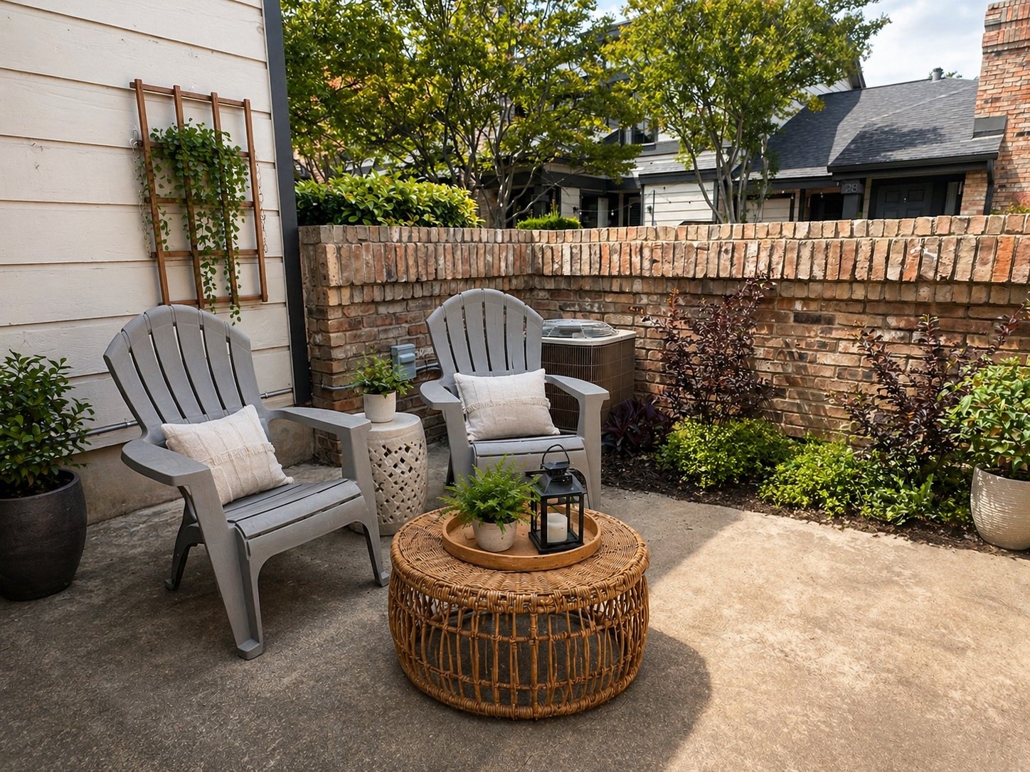 1748 Ohlen Road, Unit 22 Austin, TX 78757 - Photo 13 of 14 Private patio featuring a brick privacy wall, established landscaping, and concrete paving