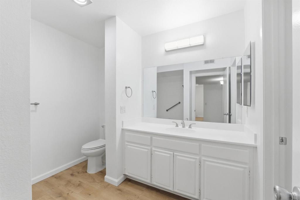 17607 Pomerado Road, Unit 107 San Diego, CA 92128 - Photo 14 of 26 a bathroom with a toilet sink and mirror