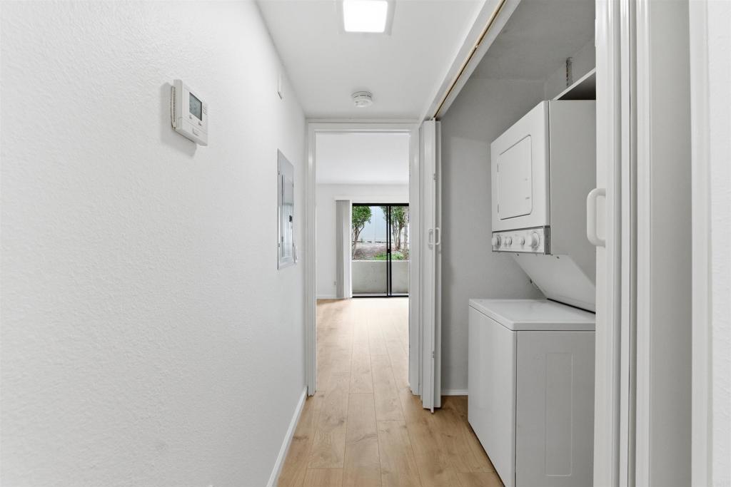 17607 Pomerado Road, Unit 107 San Diego, CA 92128 - Photo 16 of 26 a hallway with white doors and wooden floor
