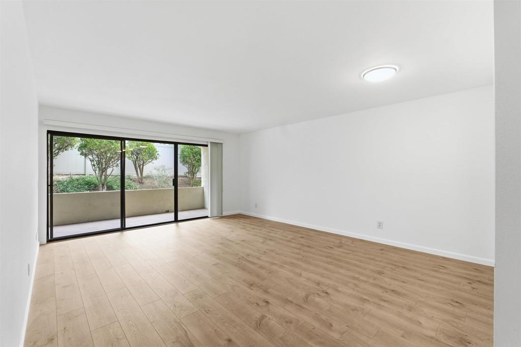 17607 Pomerado Road, Unit 107 San Diego, CA 92128 - Photo 9 of 26 a view of an empty room with wooden floor and a window