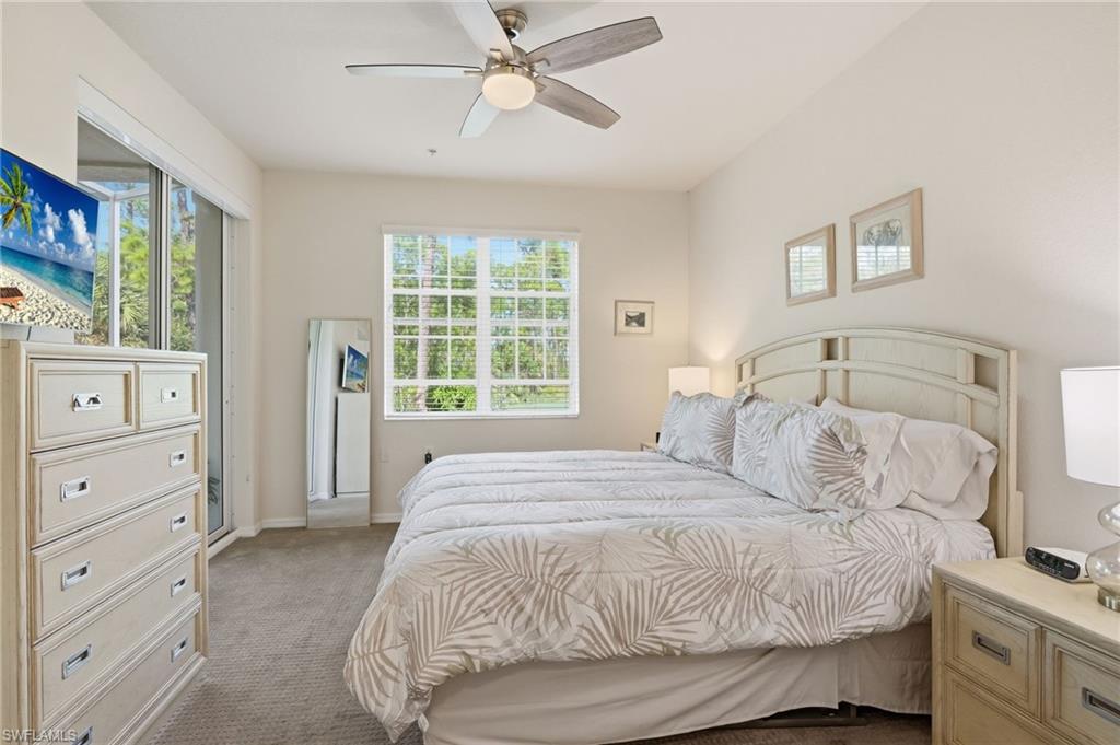 4873 Hampshire Court, Unit 104 Naples, FL 34112 - Photo 17 of 43 a bedroom with a bed and a window
