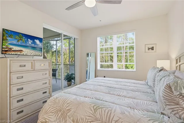 a bedroom with a bed and a flat tv screen