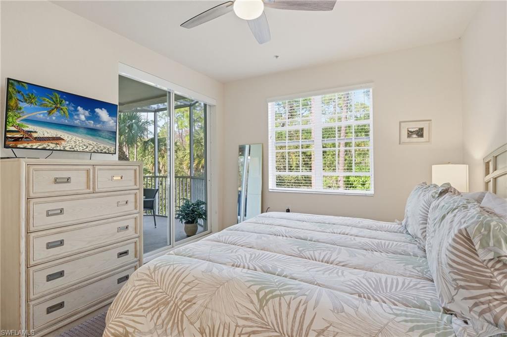 4873 Hampshire Court, Unit 104 Naples, FL 34112 - Photo 18 of 43 a bedroom with a bed and a flat tv screen