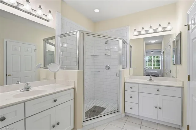 a bathroom with a shower sink double and mirror