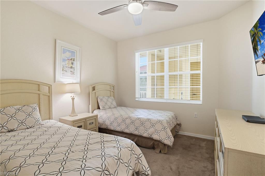 4873 Hampshire Court, Unit 104 Naples, FL 34112 - Photo 22 of 43 a bedroom with two beds and a window