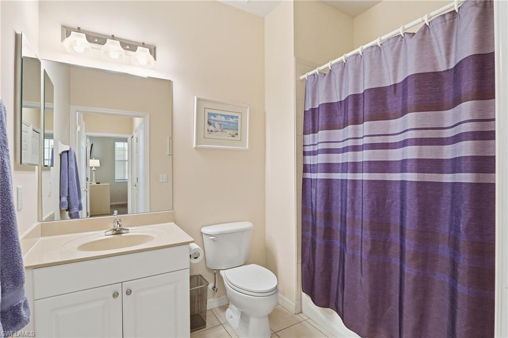 4873 Hampshire Court, Unit 104 Naples, FL 34112 - Photo 23 of 43 a bathroom with a sink a toilet and a mirror