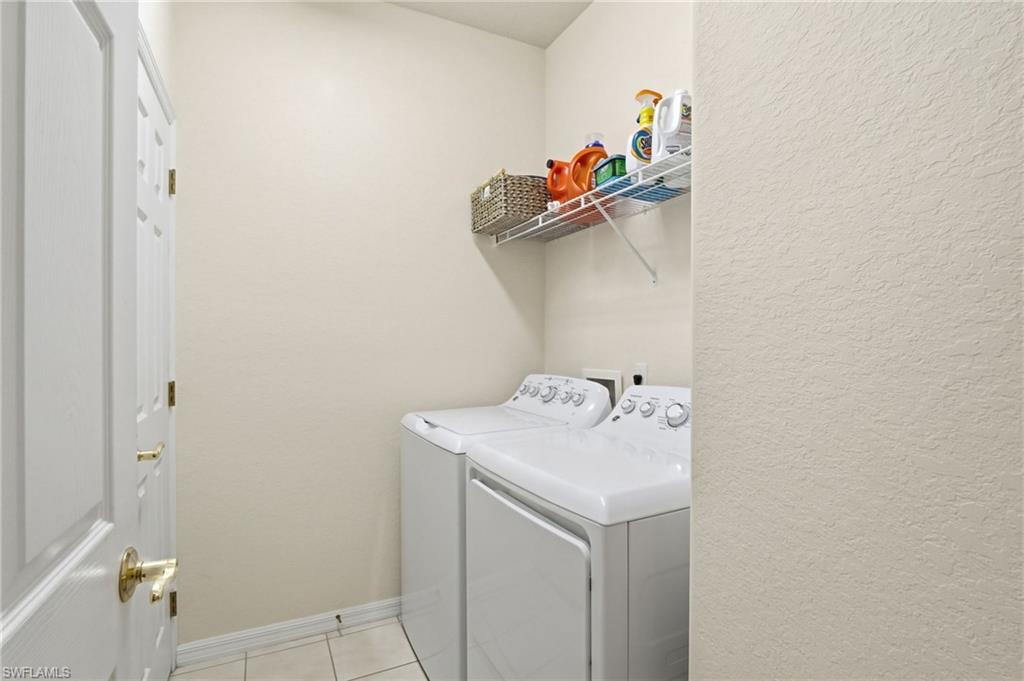 4873 Hampshire Court, Unit 104 Naples, FL 34112 - Photo 27 of 43 a utility room with dryer and washer