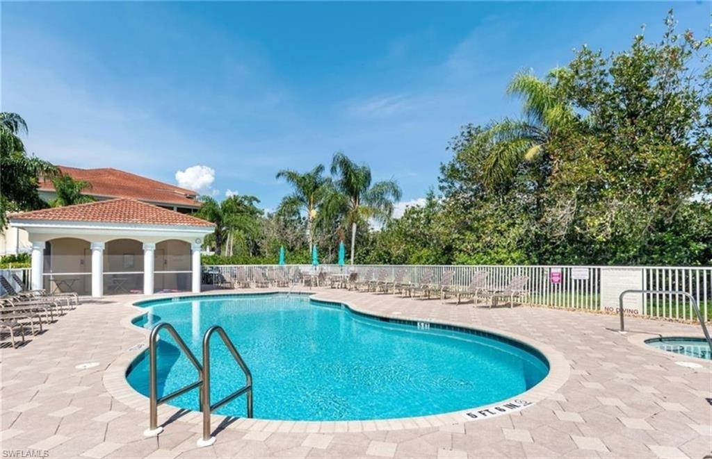 4873 Hampshire Court, Unit 104 Naples, FL 34112 - Photo 28 of 43 a view of a swimming pool with a patio