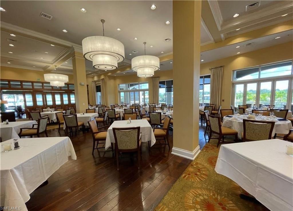 4873 Hampshire Court, Unit 104 Naples, FL 34112 - Photo 38 of 43 a living room with lots of furniture and kitchen view