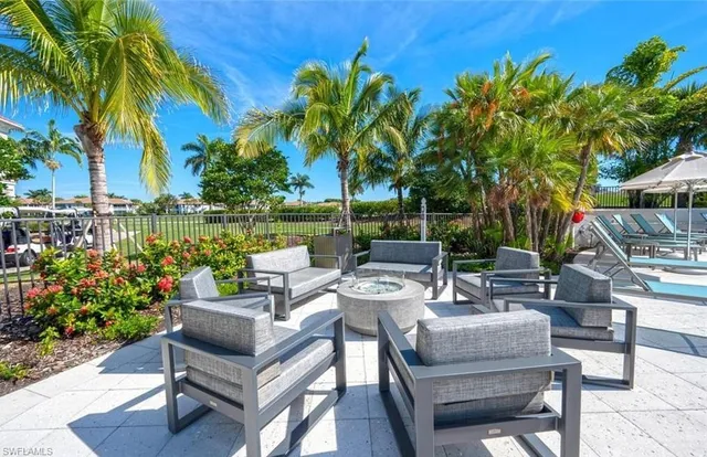 a view of a patio with couches potted plants and water view