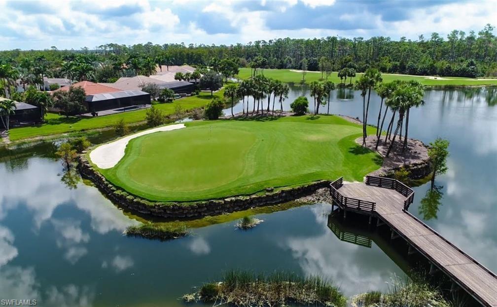 4873 Hampshire Court, Unit 104 Naples, FL 34112 - Photo 42 of 43 a view of a swimming pool with a lake view