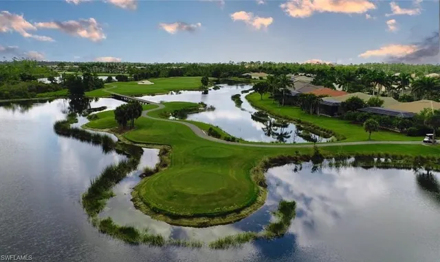 an aerial view of a house a yard and lake view
