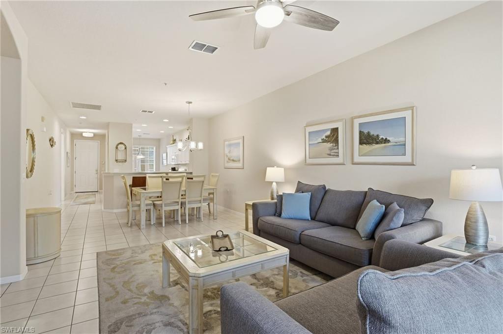4873 Hampshire Court, Unit 104 Naples, FL 34112 - Photo 6 of 43 a living room with furniture and a view of kitchen