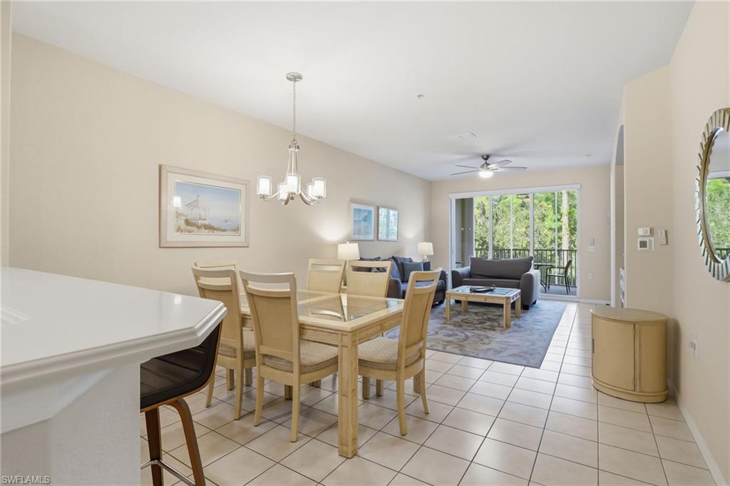 4873 Hampshire Court, Unit 104 Naples, FL 34112 - Photo 7 of 43 a view of a dining room with furniture