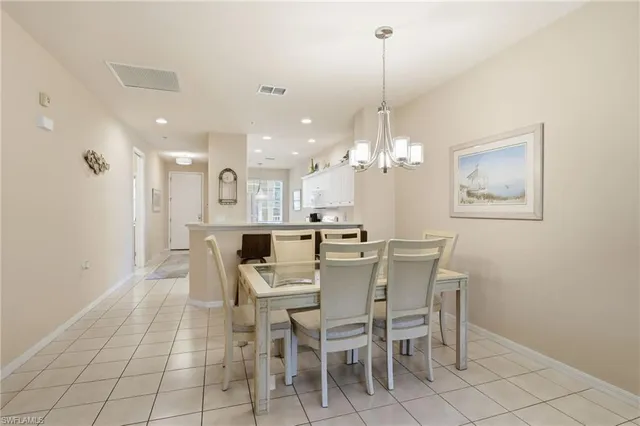 a view of a dining room with furniture and chandelier