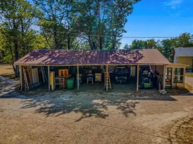 a view of a cafe with a table and chairs under an umbrella