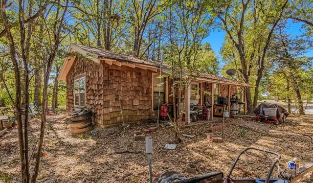 a view of a chairs and table in the backyard