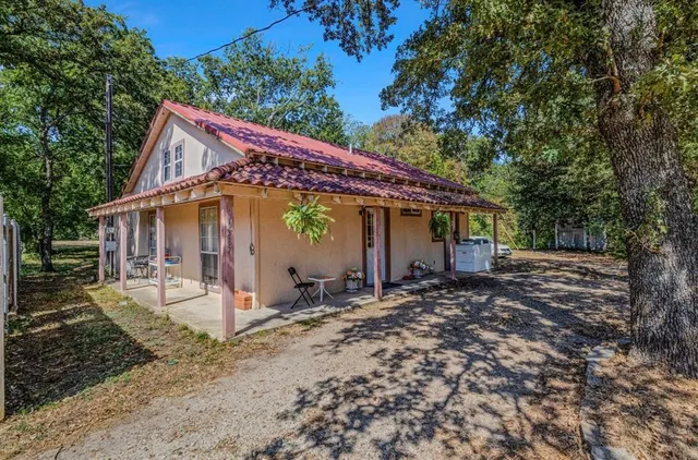 a view of a house with a yard and sitting area
