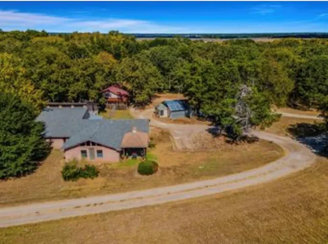 an aerial view of a house with yard swimming pool and outdoor seating