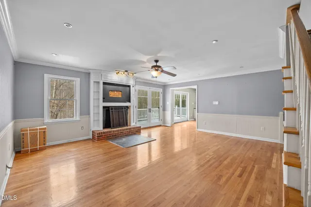 wooden floor in an empty room with a window