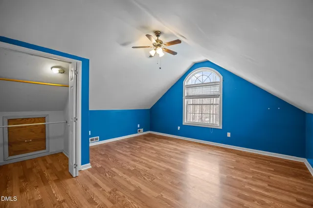 a bathroom with a granite countertop toilet sink and mirror