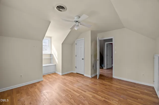 a view of a house with a wooden fence